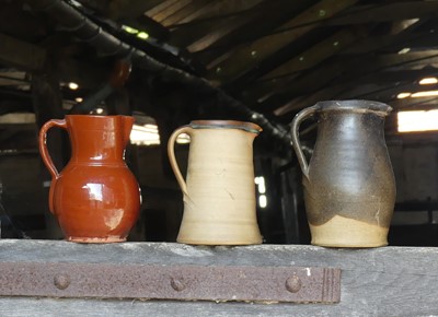 Lot 233 - Three various studio pottery single handled...