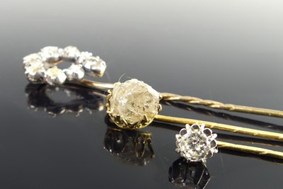 Lot 2818 - Three yellow metal diamond stick pins, one...