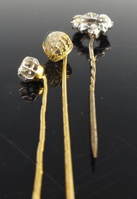 Lot 2818 - Three yellow metal diamond stick pins, one...
