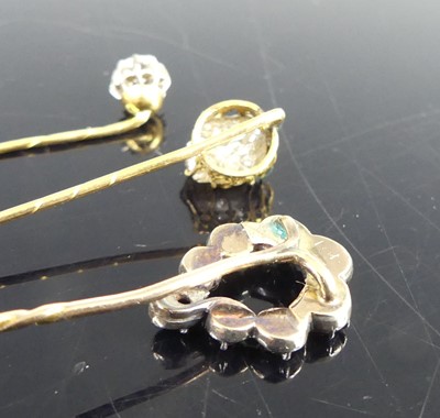 Lot 2818 - Three yellow metal diamond stick pins, one...