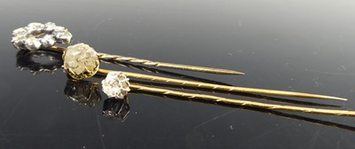 Lot 2818 - Three yellow metal diamond stick pins, one...