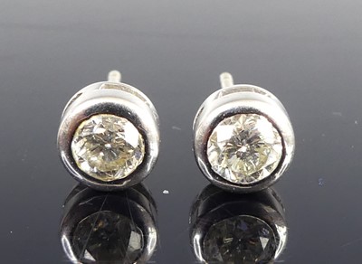 Lot 2831 - A pair of 18ct white gold diamond stud...