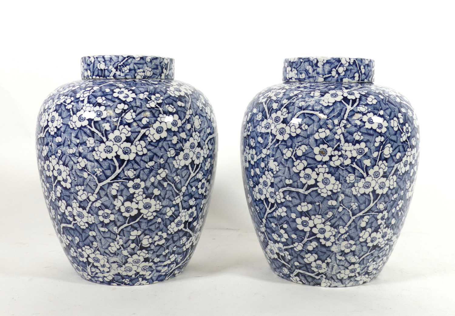 Lot 11 - A pair of transfer decorated pottery jars and...