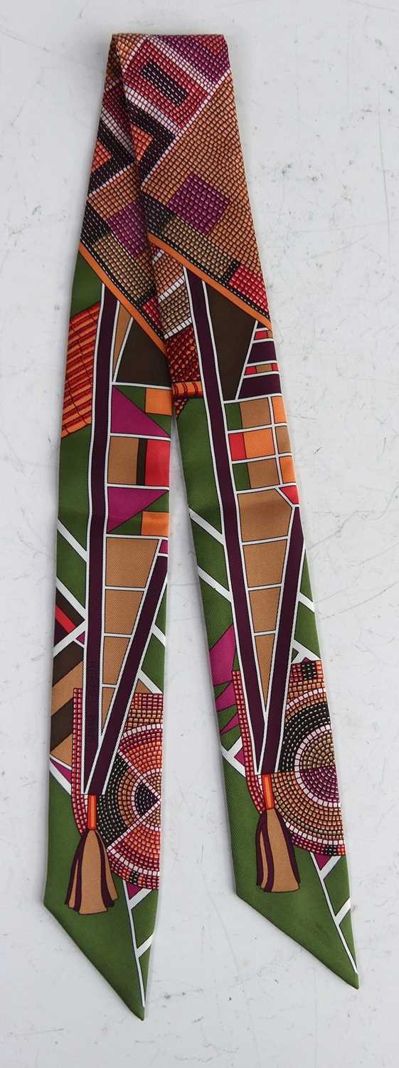 Lot 146 - Hermès - a Twilly silk scarf, bright colour...