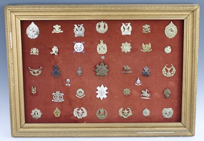 Lot 3397 - A collection of cap badges and insignia to...