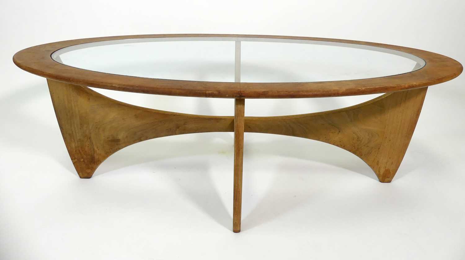 Lot 369 - A 1960s G-Plan teak 'Astro' oval coffee table,...