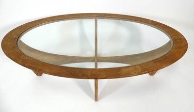 Lot 369 - A 1960s G-Plan teak 'Astro' oval coffee table,...