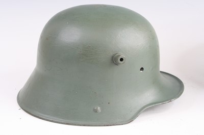 Lot 3401 - A German M16 steel helmet, later green painted,...