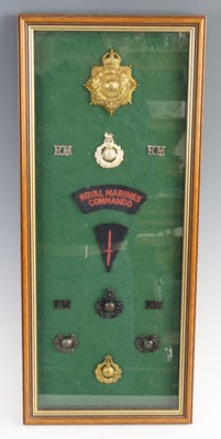 Lot 3446 - A framed display of Royal Marines insignia to...
