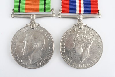 Lot 3469 - A WW II Defence and War medal pair, together...