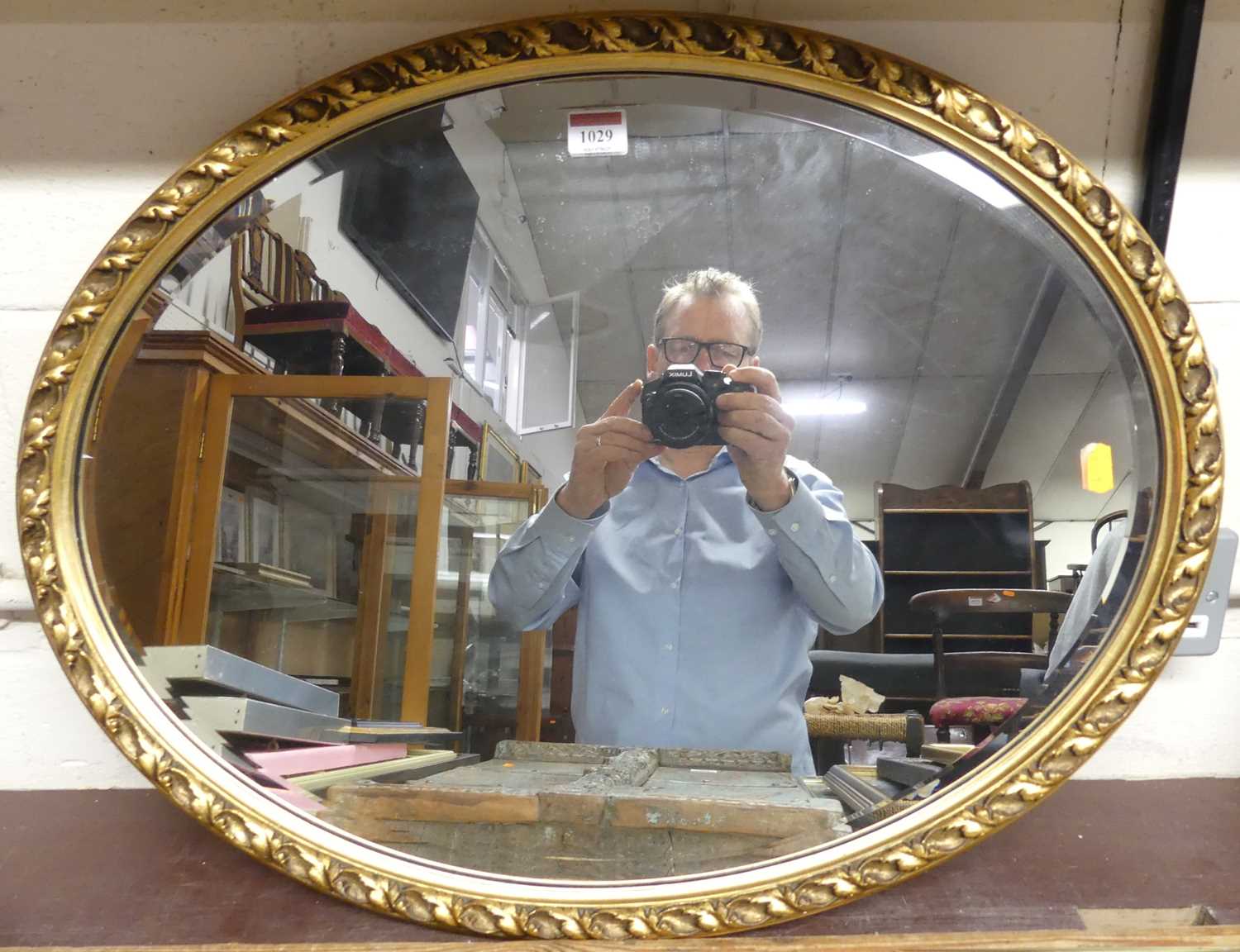 Lot 1029 - A gilt framed and composition over wall mirror,...