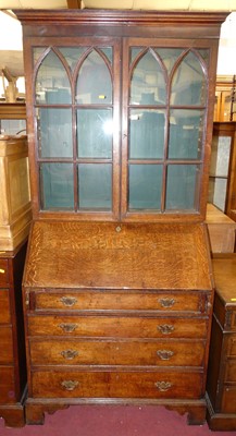 Lot 1369 - An early 19th century oak bureau bookcase,...