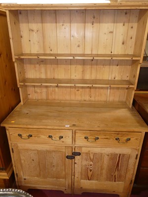 Lot 1373 - A rustic pine kitchen dresser, having two-tier...