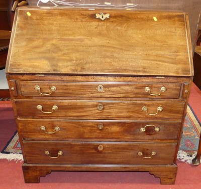 Lot 1405 - A George III mahogany slopefront writing...