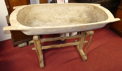 Lot 1409 - A provincial carved soft wood trough on stand