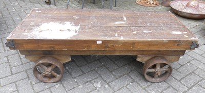 Lot 1425 - A stained pine and metal bound wheeled cart,...