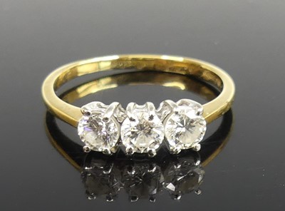 Lot 2262 - An 18ct yellow and white gold diamond trilogy...