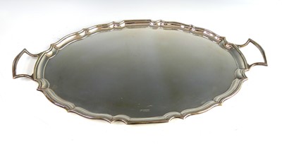 Lot 2195 - A George V silver twin handled drinks tray, of...