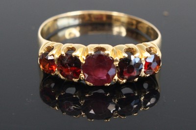 Lot 300 - An 18ct yellow gold garnet half-hoop eternity...