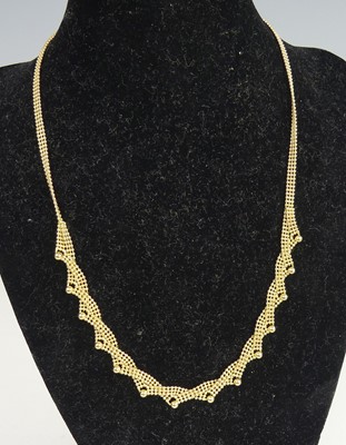 Lot 2314 - A yellow metal three-row bead link necklet,...