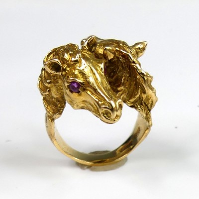 Lot 2269 - An 18ct yellow gold double horse head ring,...