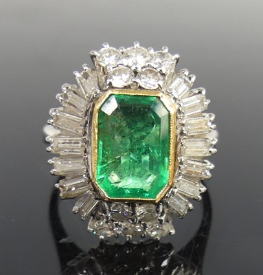 Lot 2330 - A white metal, emerald and diamond oval...