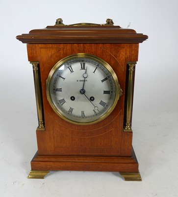 Lot 125 - An Edwardian walnut mantel clock, the case...