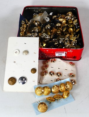 Lot 389 - A tin of mainly WW2 brass and composite...