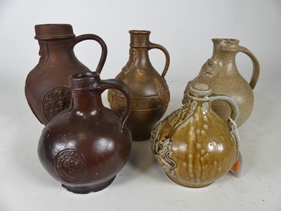 Lot 144 - A collection of five German Bartmann jugs,...