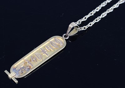 Lot 323 - An Egyptian yellow metal pendant decorated...