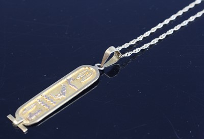 Lot 340 - An Egyptian yellow metal pendant decorated...