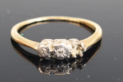 Lot 369 - An 18ct gold diamond three-stone ring (one...