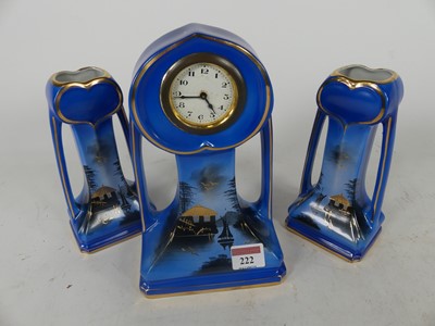Lot 222 - A pottery three-piece clock garniture,...