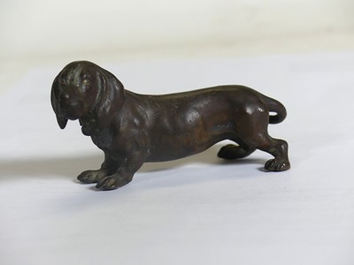 Lot 417 - A patinated bronze model of a dachshund,...