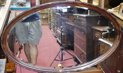 Lot 1015 - Mahogany framed and bevelled oval wall mirror,...