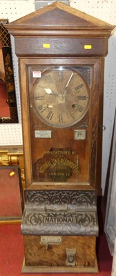 Lot 1146 - An early 20th century oak clocking-in /...
