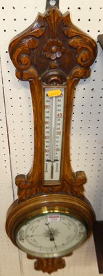 Lot 1156 - A floral carved oak aneroid two-dial wheel...