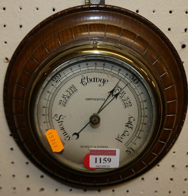 Lot 1159 - An oak aneroid circular barometer by Negretti...