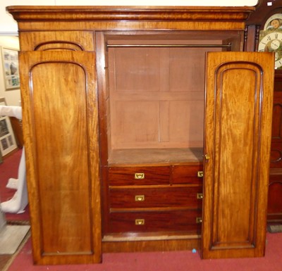 Lot 1177 - A mid-Victorian round cornered triple wardrobe,...