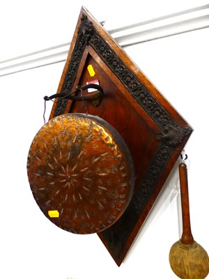Lot 601 - A hammered copper dinner gong mounted on a...