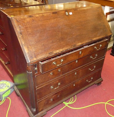 Lot 1215 - A George III mahogany slopefront writing...