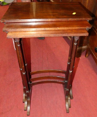 Lot 1244 - A mahogany nest of three occasional tables, on...
