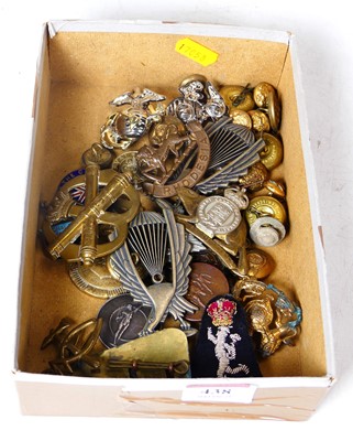 Lot 438 - A collection of military cap badges and...