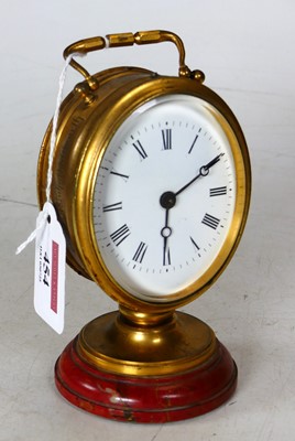 Lot 454 - A Victorian gilt brass bedside clock of oval...