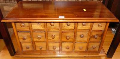 Lot 1291 - A contemporary hardwood table-top bank of...
