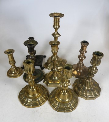 Lot 484 - A collection of brass table candlesticks,...