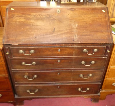 Lot 1306 - A George III mahogany slopefront writing...