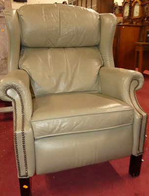 Lot 1374 - A sage green leather upholstered and brass...