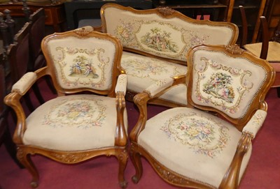 Lot 1392 - A Louis XV style carved walnut three-piece...