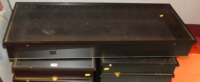 Lot 1073 - A set of eight ebonised glazed wall mounted...